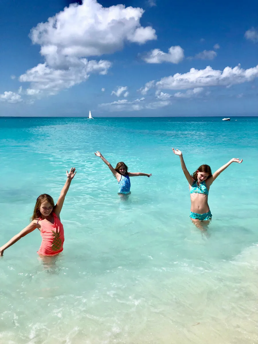 Girls swimming in Grace Bay at Turks and Caicos