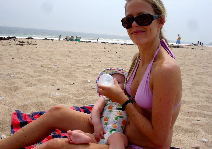 Bottle feeding on family vacation at beach