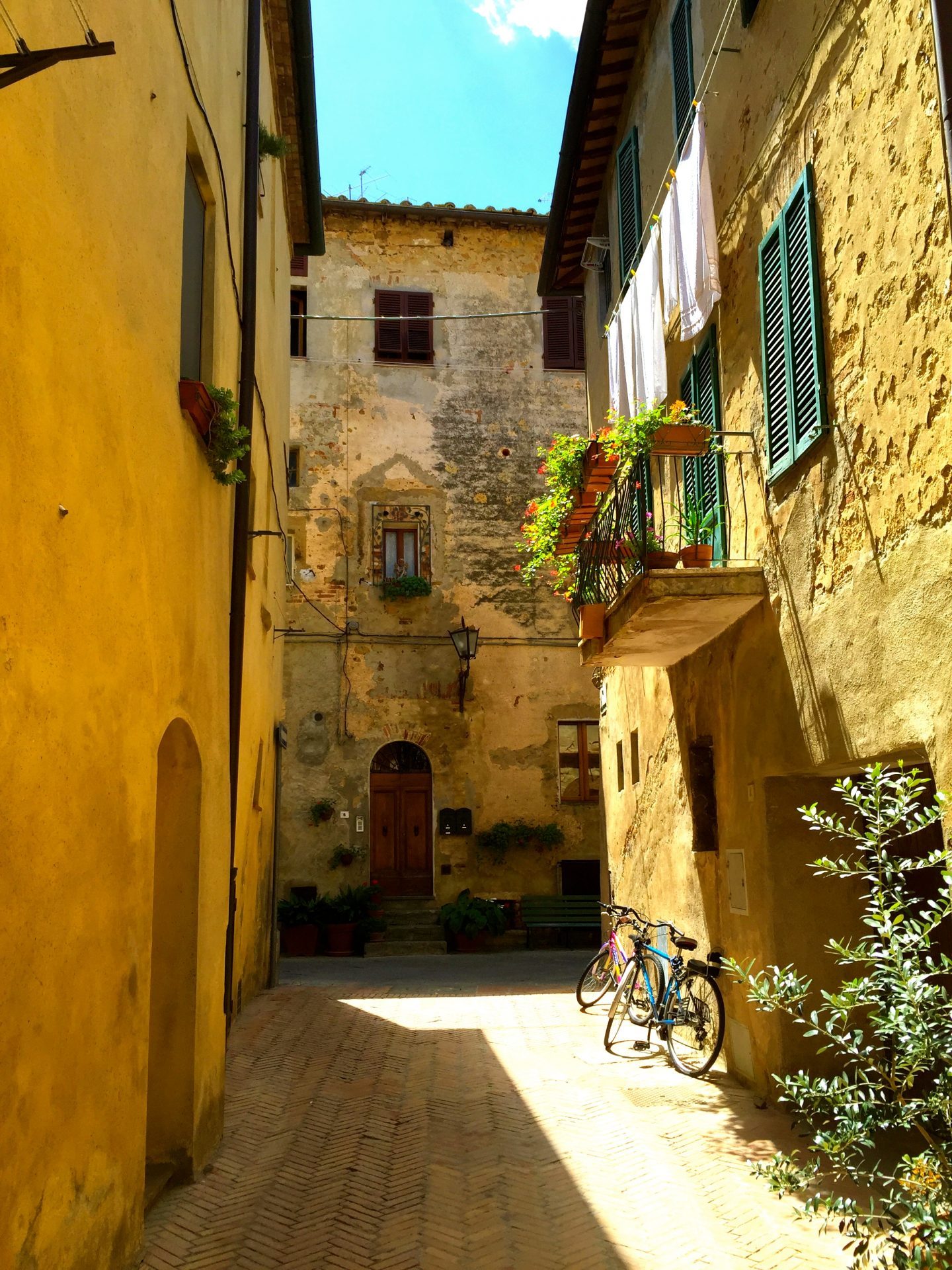 Walking down an alleyway in Pienza Tuscany.