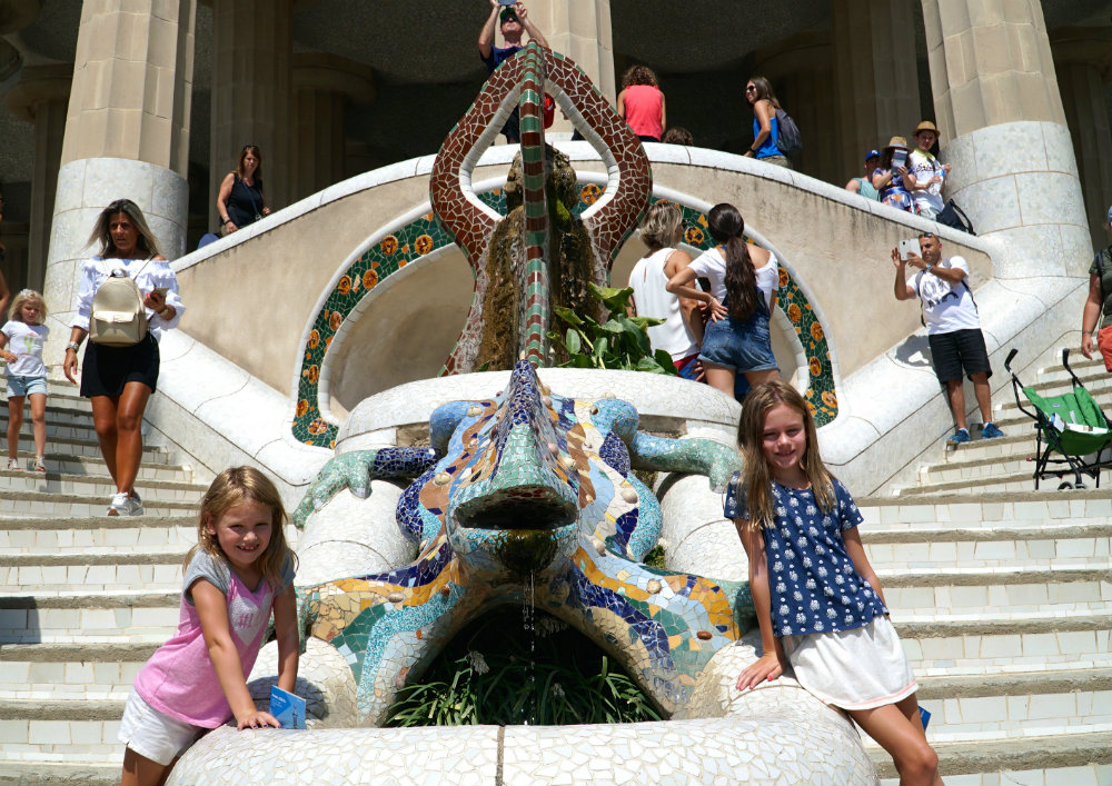 Girls with mosaic lizard at Park Guell, designed by Gaudi.