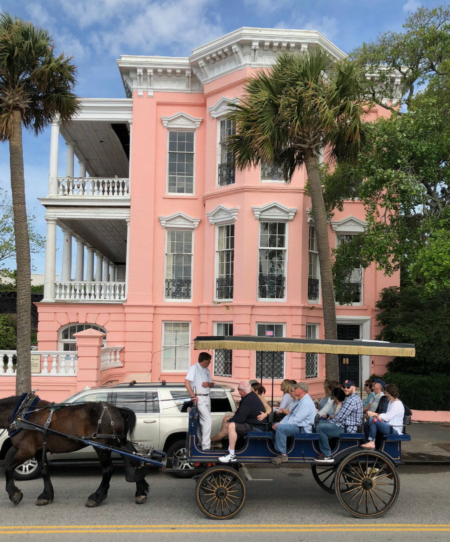 Pink mansion with horse drawn carriage in Charleston