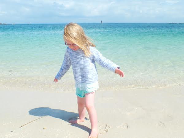 Kids playing on the beach in Finestere, Brittany, France on a summer vacation.