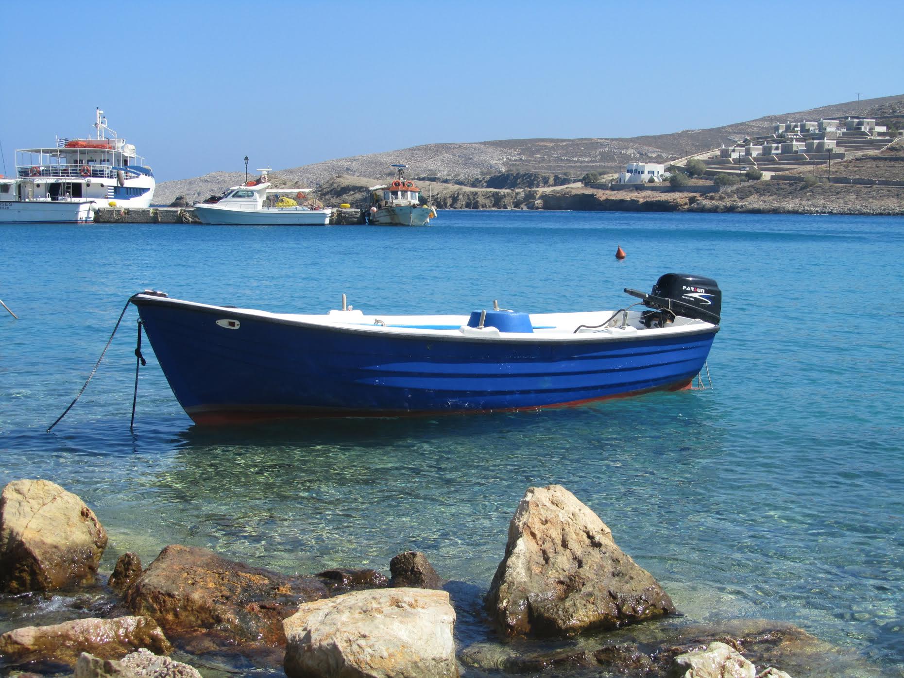 Pretty harbor in the Greek Islands with small boat.