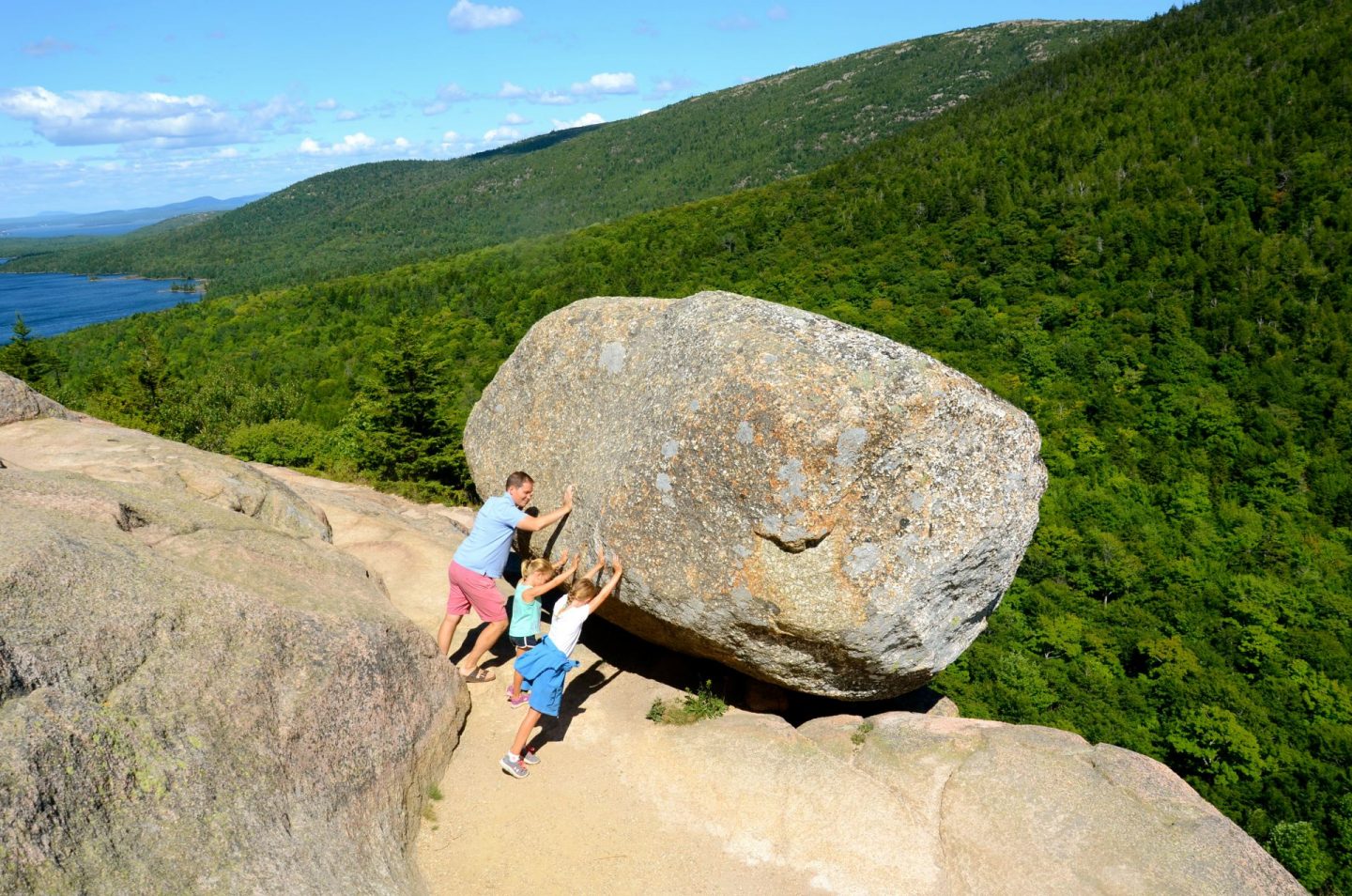 Hiking up to Bubble Rock in Acadia National Park for a summer family vacation.