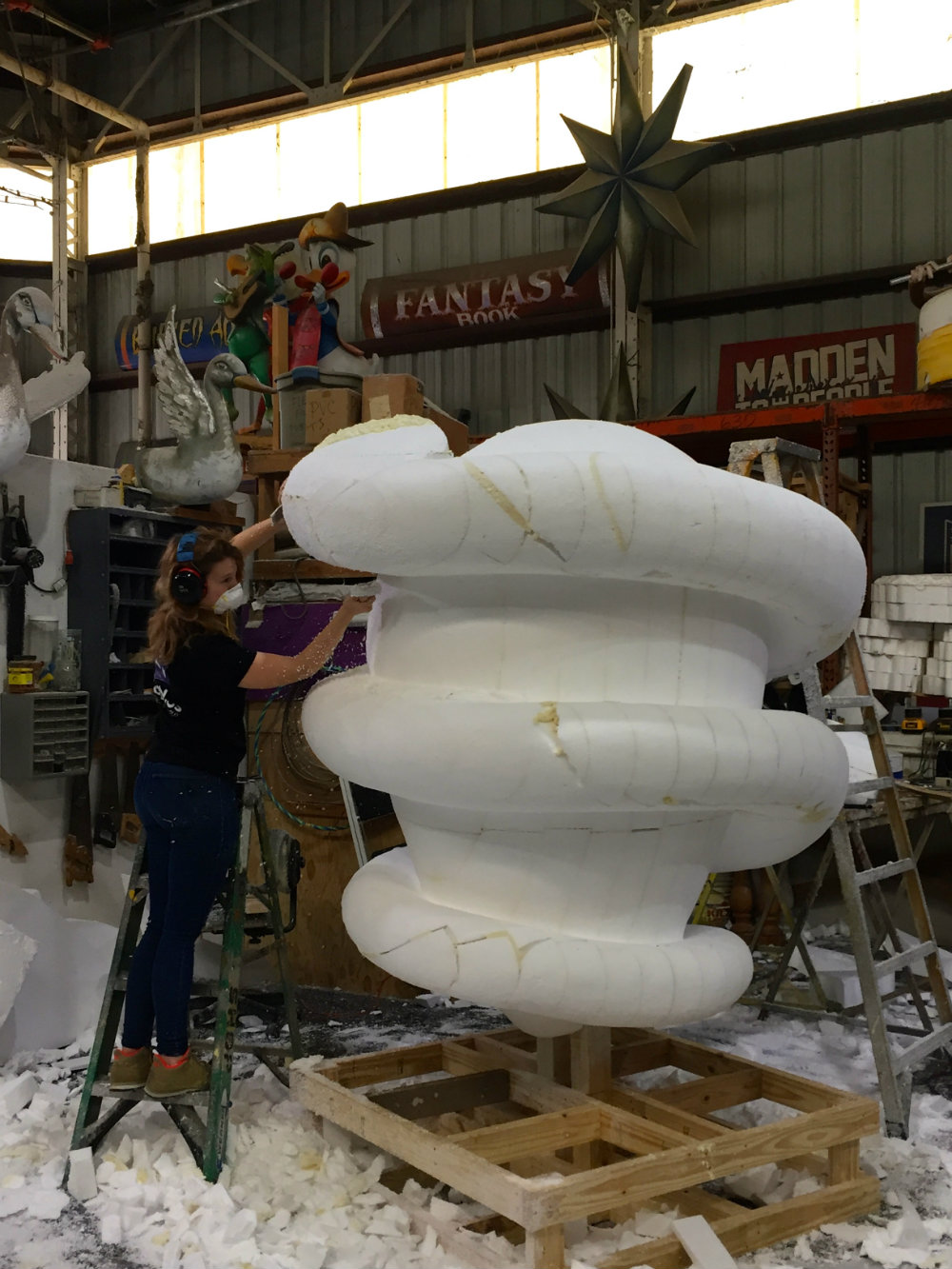 Artist working on a float at Mardi Gras World.