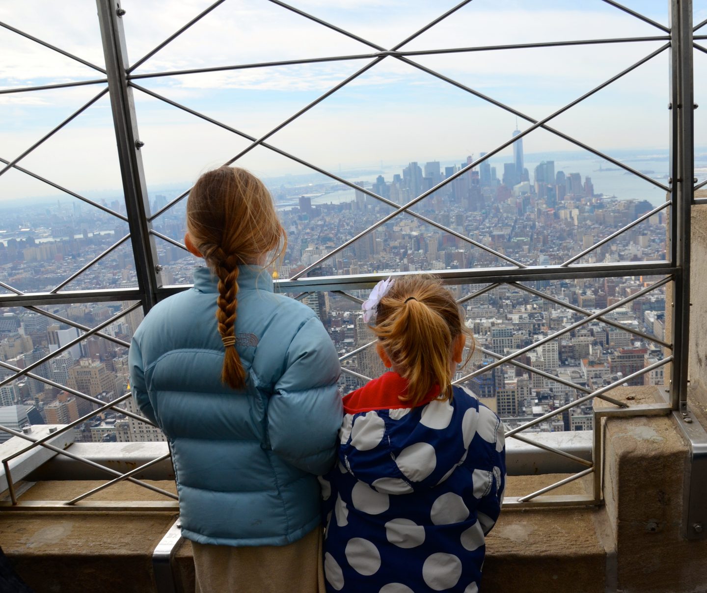 Kids looking out onto Manhattan from the top of the Empire State Building