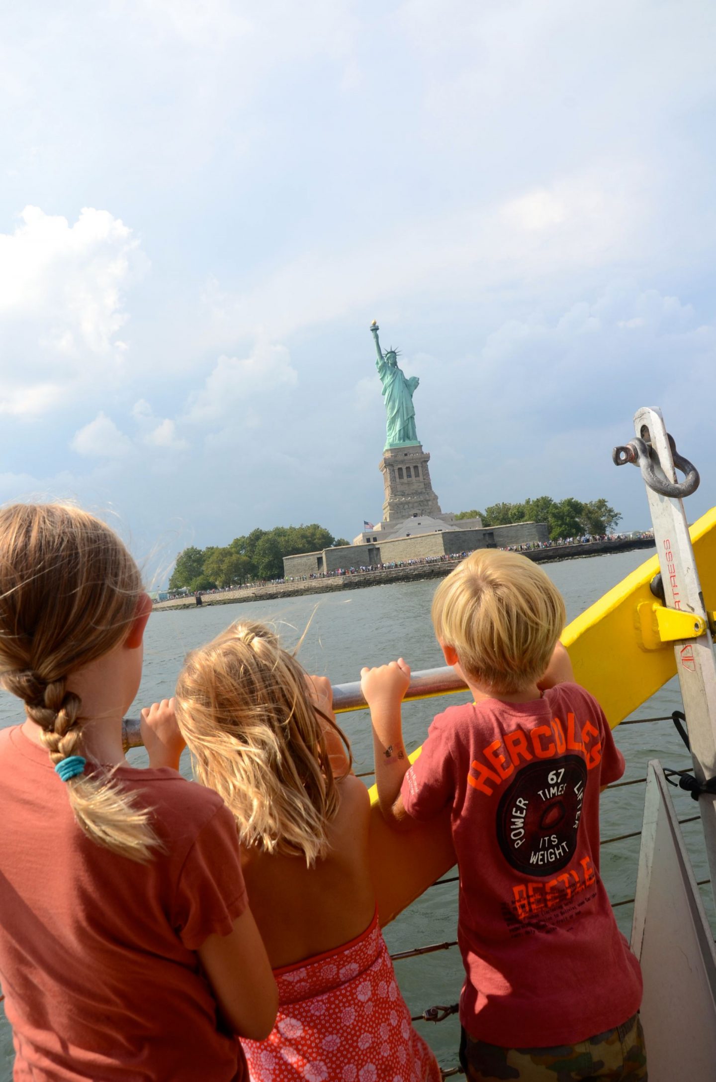 Kids looking at the Statue of Liberty from the New York Water Taxi.