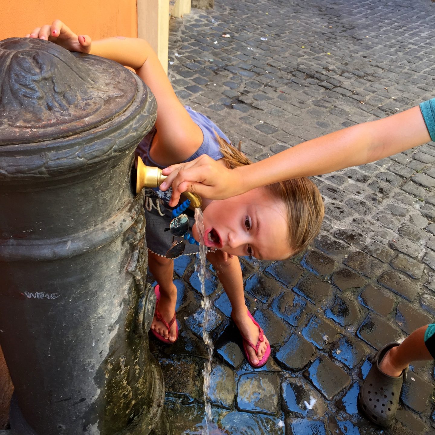 Drinking out of the water fountain in Rome.