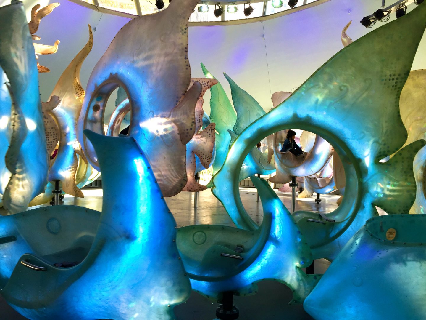 Admiring the fish seats in the Seaglass carousel in Battery Park, New York City.