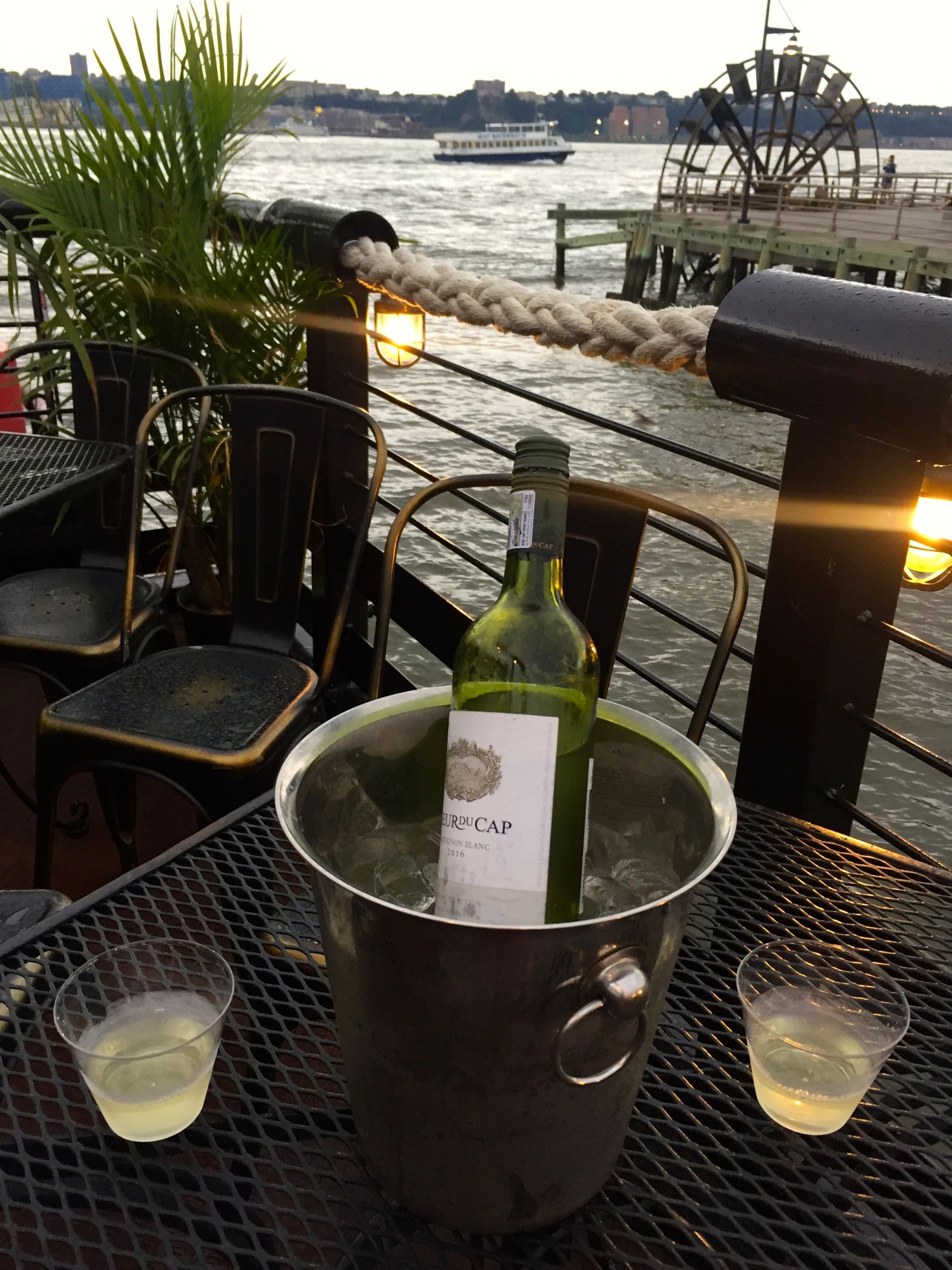 Drinking a bottle of wine at the Frying Pan in New York City in the summer.
