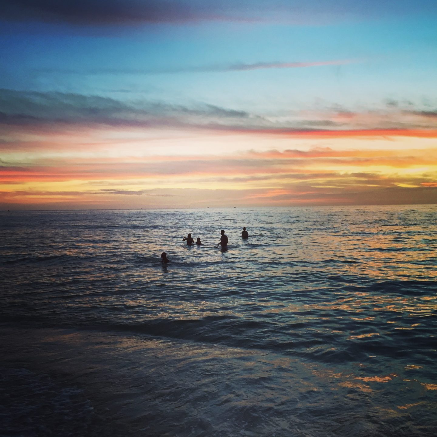 Swimming in the gulf at sunset in Naples Florida.