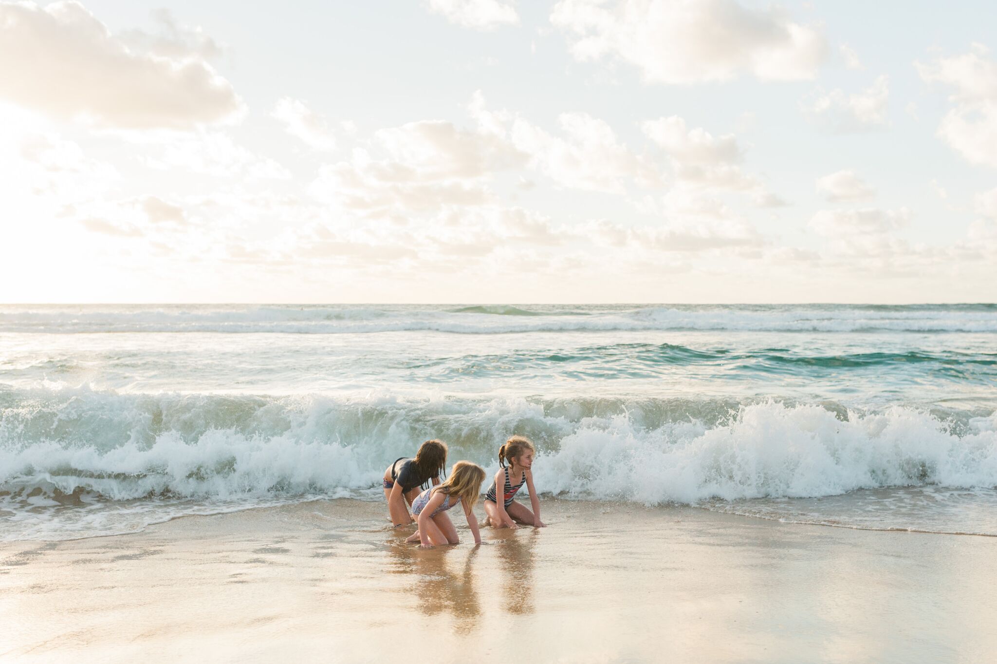 Wading in the ocean on the beach.